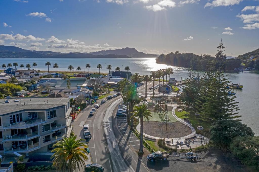 arial view of a city with a river and palm trees at Esplanade Apartments in Whitianga