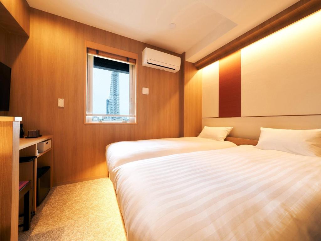 a hotel room with two beds and a window at Rakuten STAY Tokyo Asakusa Twin Room in Tokyo