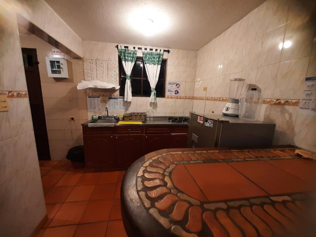 a kitchen with a baseball field on the floor at Aparta Hotel El Refugio de María in Villa de Leyva