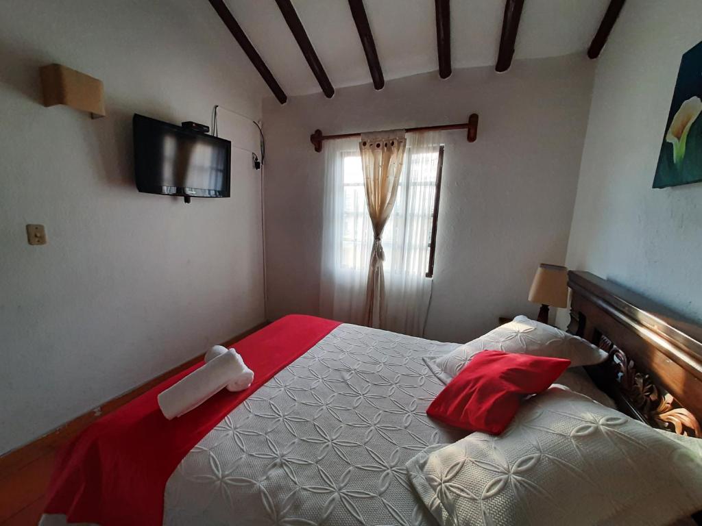 Postel nebo postele na pokoji v ubytování Aparta Hotel El Refugio de María