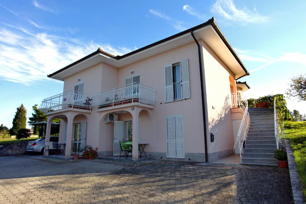 a large white house with a staircase in front at Marija's House in Portorož