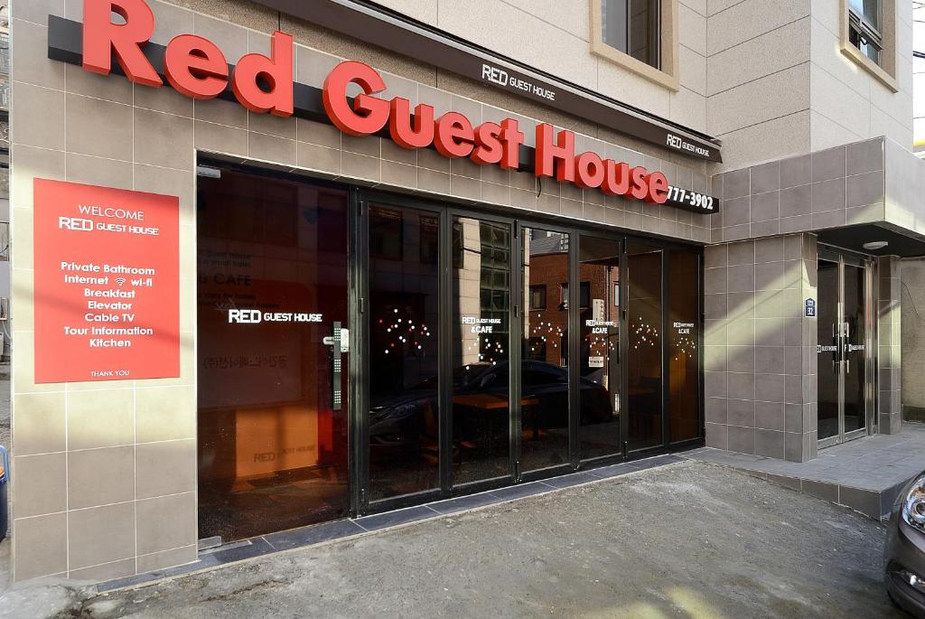 a red guest house sign on the side of a building at Red Guesthouse in Seoul