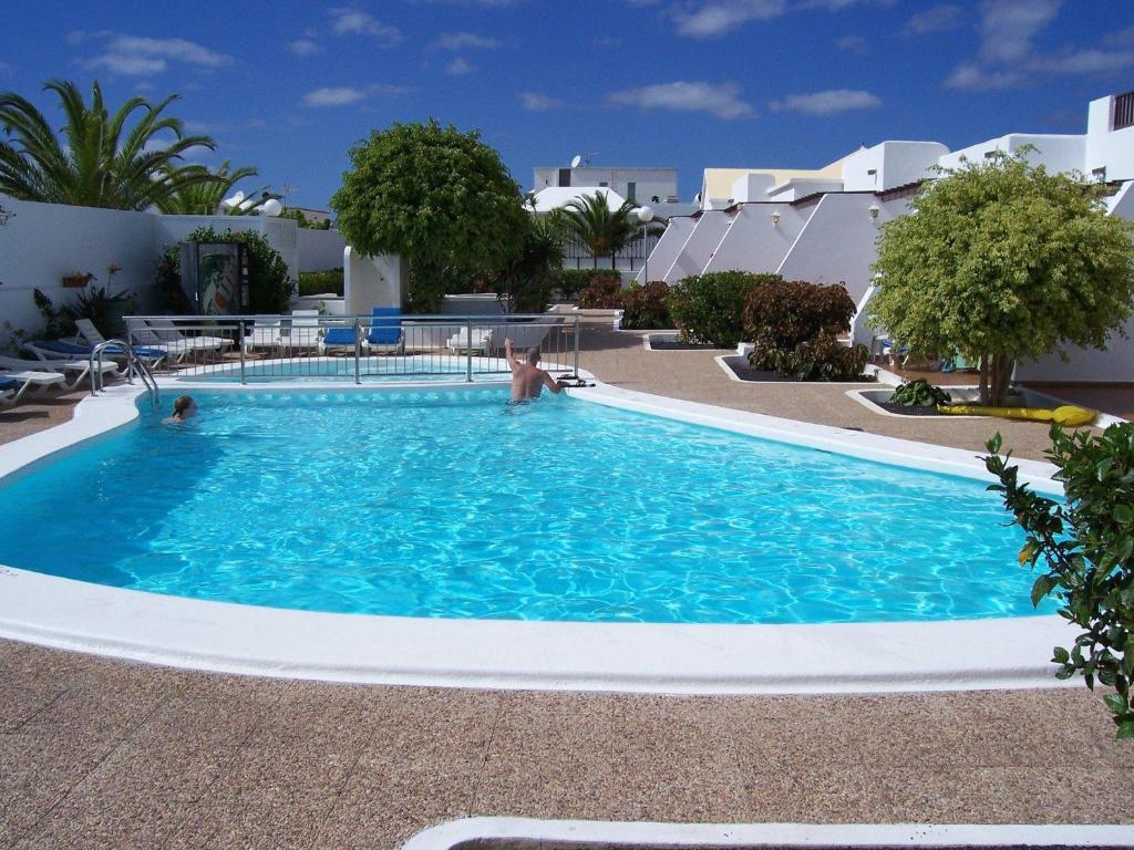 a large pool with blue water in a resort at La Laguneta in Puerto del Carmen