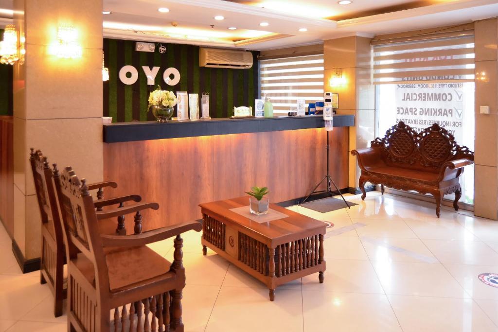 a lobby with a waiting area with chairs and a table at Super OYO 791 Bell Mansion in Manila