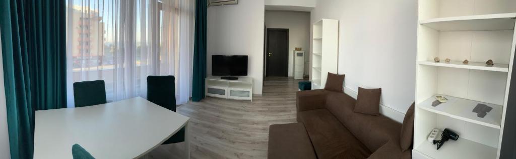 a living room with a table and a television at Perfect Spot Summerland Mamaia in Mamaia