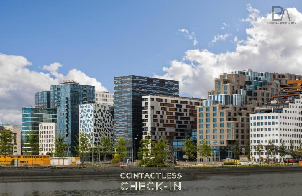 een groep hoge gebouwen in een stad bij BJØRVIKA APARTMENTS, Opera Area, Oslo city center in Oslo