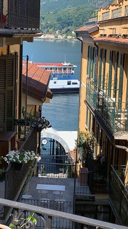 a boat in the water between two buildings at 6alcentrale in Bellagio