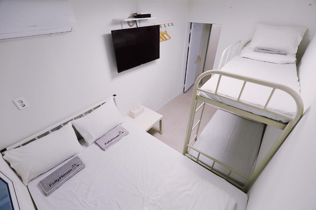 Postel nebo postele na pokoji v ubytování Fully Mini Hotel