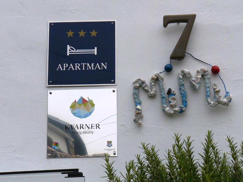 a sign on the side of a building that says apartmentarian at Mimi in Jadranovo