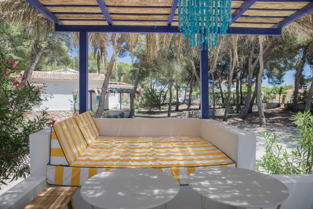 a patio with a couch and two tables at Quinta la Sal in Jávea