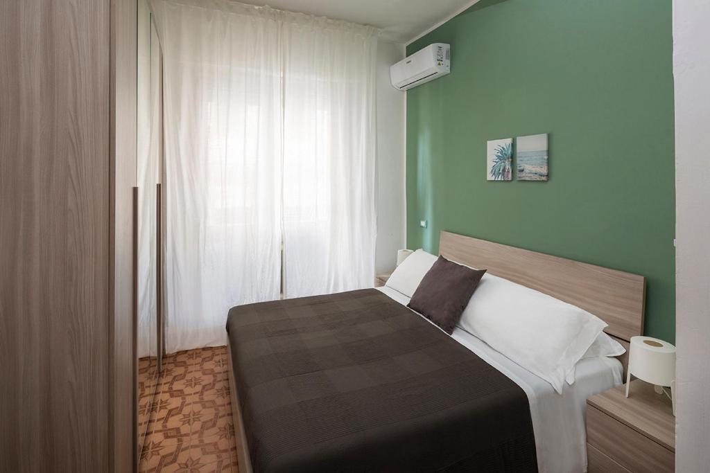 Posteľ alebo postele v izbe v ubytovaní Appartamenti Villa Miramare