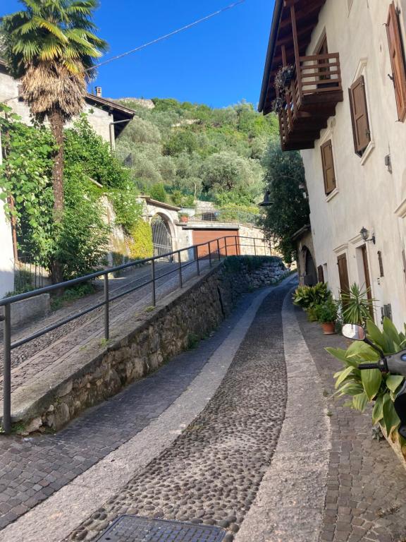 a cobblestone street next to a building with a palm tree at ON the RAIL by Arcotrilogy-Homes in Arco