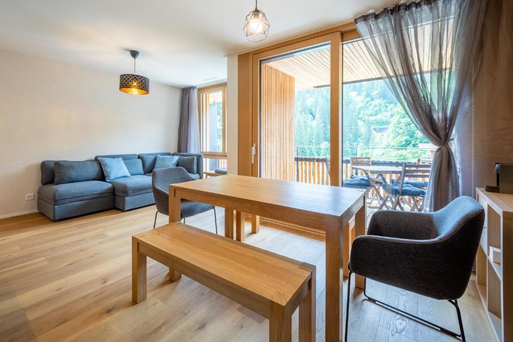 a living room with a table and a couch at Vallada 14 01 in Flims