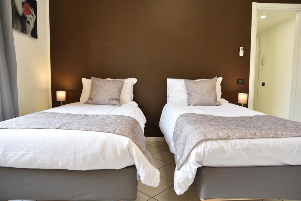 Postel nebo postele na pokoji v ubytování Rho Fiera Flat