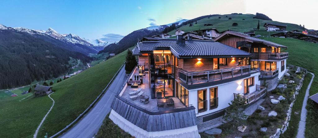 a large house on top of a hill at Chalet´s Alpenjuwel in Tux