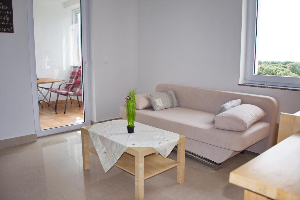 a living room with a couch and a table at Apartment Noel in Novalja