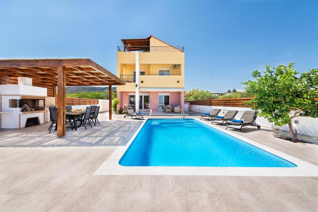 a villa with a swimming pool and a house at Ritas Gennadi Villa in Gennadi