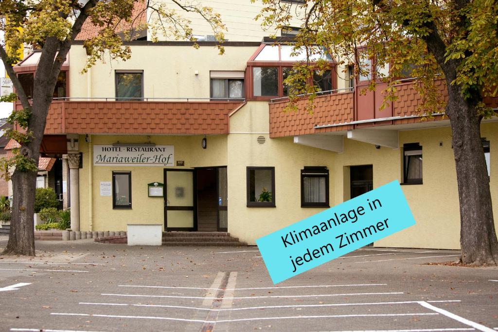 a building with a sign in front of it at Mariaweiler Hof in Düren - Eifel