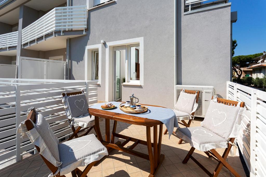 a patio with a table and chairs on a balcony at Appartamenti Villa Miramare in Rimini