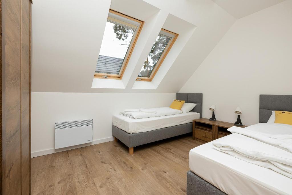 Posteľ alebo postele v izbe v ubytovaní Apartamenty Zielona 11 by Noclegi Renters