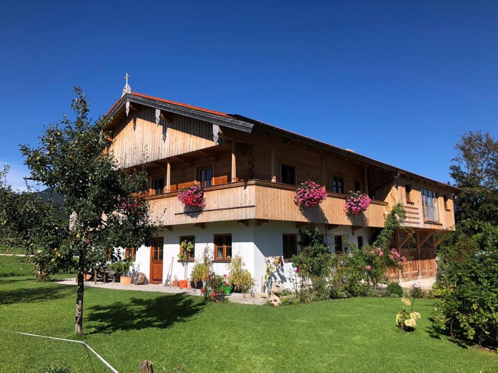 una casa grande con un patio delante en Ferienwohnung Sundratn, en Wackersberg