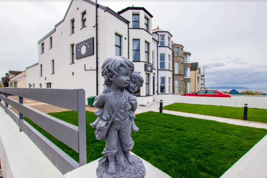 a statue of a little boy standing in front of a building at Station 36 in Portstewart