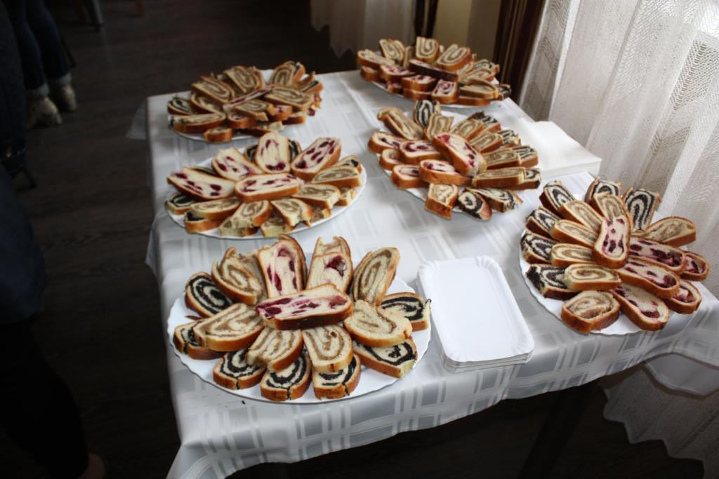 a table with several plates of pastries on it at Apartmani Čižmešija in Tkon