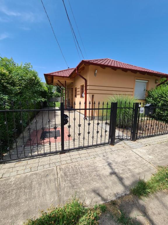 a fence in front of a house at Zseki apartman in Hajdúszoboszló