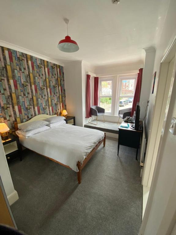 a bedroom with a bed and a living room at The Sandhaven in Swanage