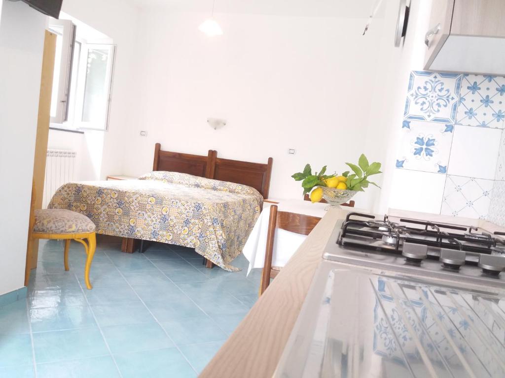 a kitchen with a stove top oven in a room at GRomano Apartments in Ischia