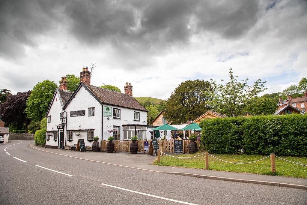 a white house on the side of a road at The Yew Tree Inn in Church Stretton