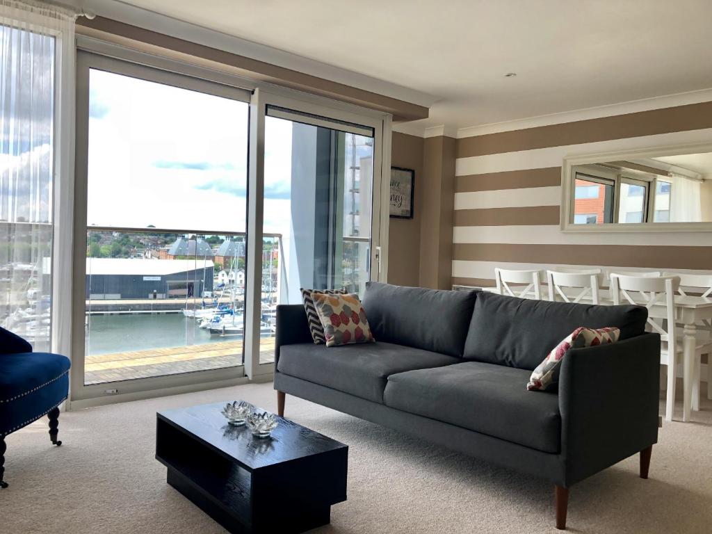 a living room with a couch and a table at Toothbrush Apartments - Ipswich Waterfront - Anchor St in Ipswich