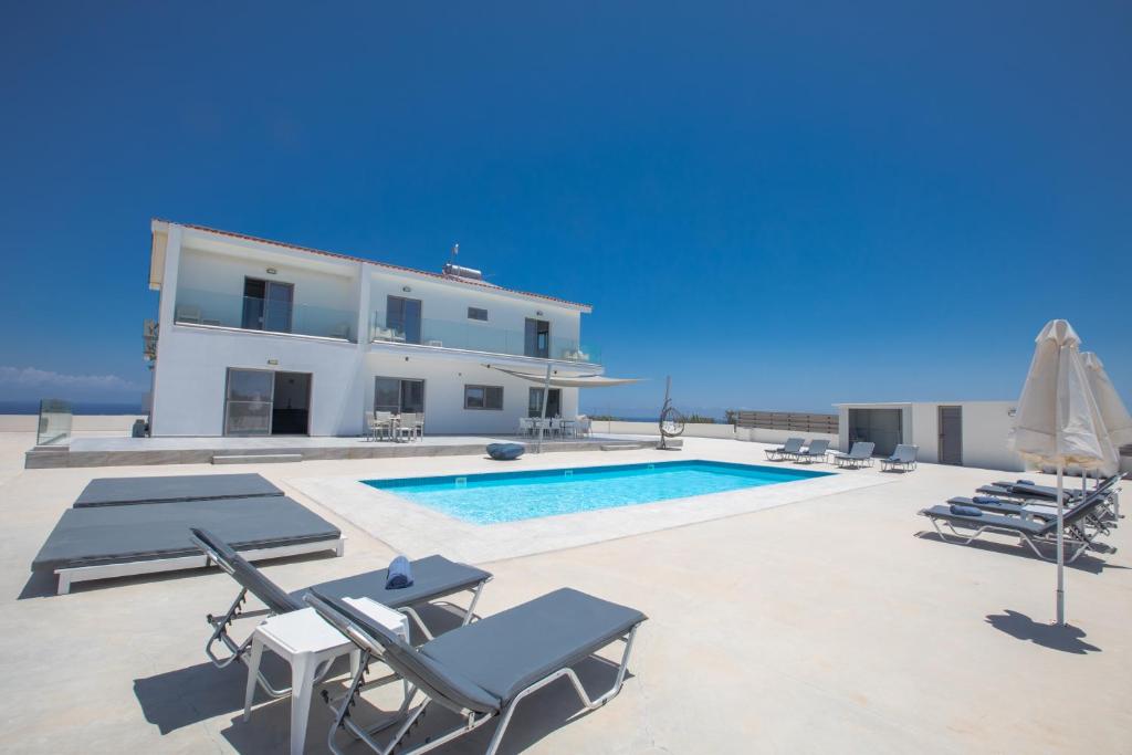 a villa with a swimming pool and a house at Villa Marylou in Protaras
