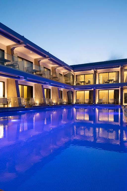 a large building with a swimming pool at night at Akti Toroni Boutique Hotel in Toroni