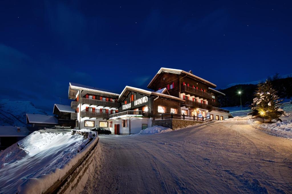 a snow covered ski slope with a ski lift at Hotel Teola in Livigno