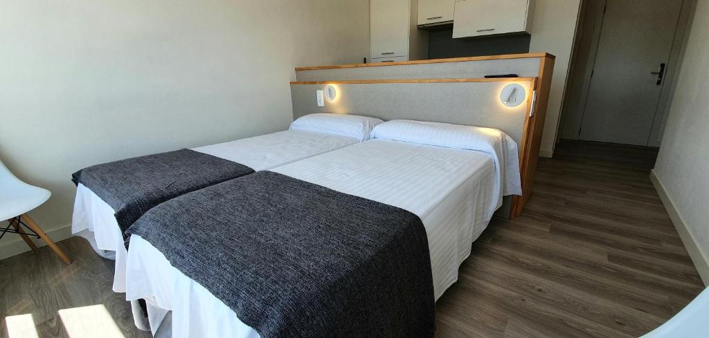 A bed or beds in a room at Apartamentos Costa da Morte Muxia