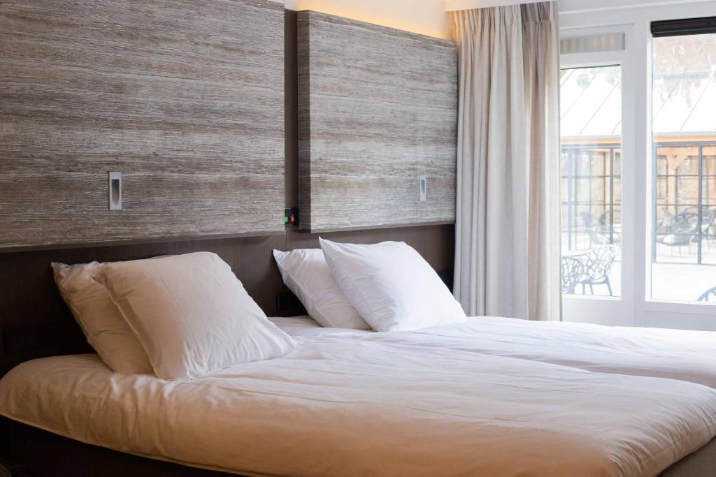 Postel nebo postele na pokoji v ubytování Hotel de Werelt