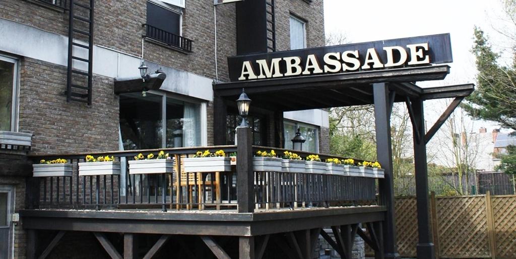 a sign for an amazonasade in front of a building at Hotel Ambassade in Waregem