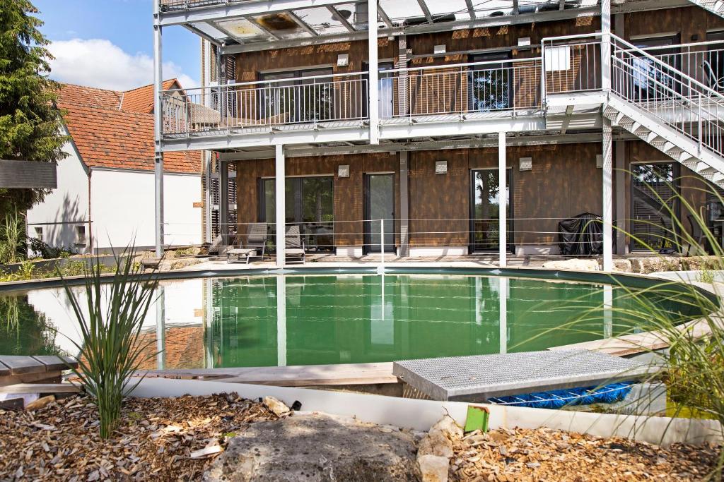 a swimming pool in front of a building at Ferienwohnung Donautal 