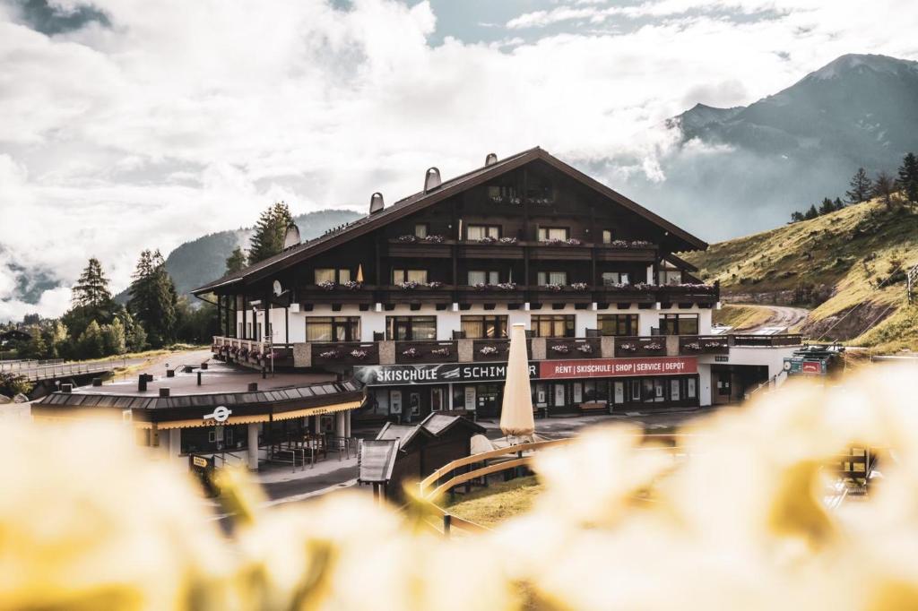 a large building in front of a mountain at Appartementhaus Am Gschwandtkopf in Seefeld in Tirol