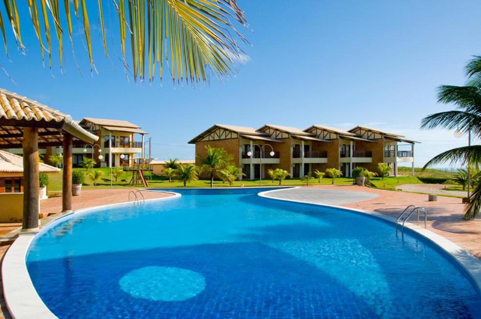 una grande piscina blu di fronte a un resort di Recanto Zumbi Apartamento TOP C12 a Zumbi (Rio do Fogo)