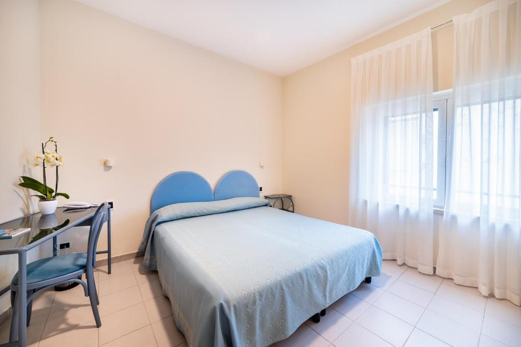 Postel nebo postele na pokoji v ubytování Hotel Il Gabbiano