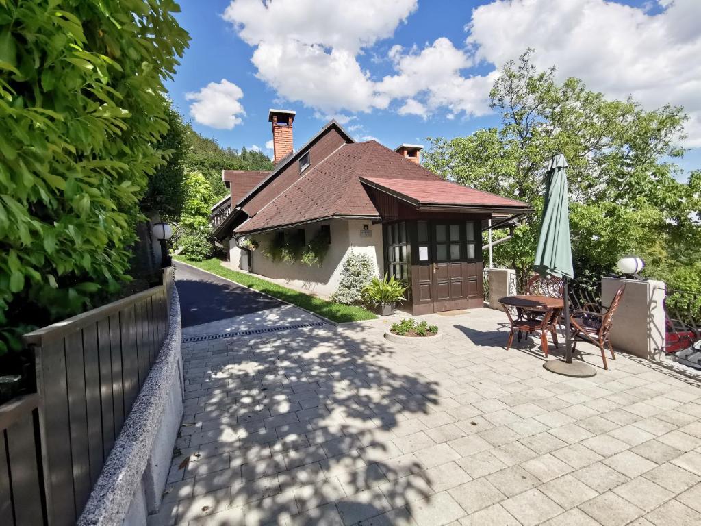 a house with a patio and an umbrella at Apartmaji Mak in Jesenice