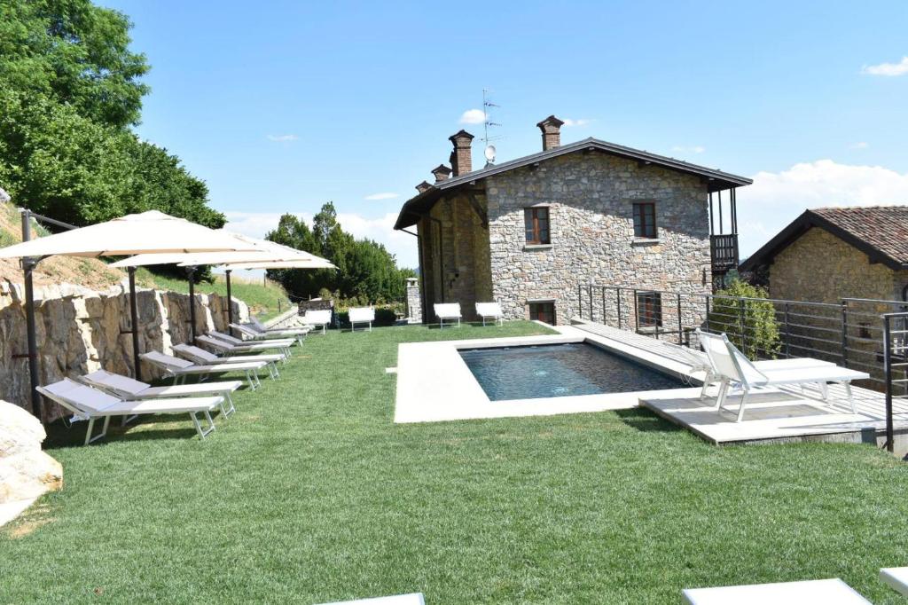 a group of lounge chairs sitting next to a building at Cascina Belvedì in Clanezzo