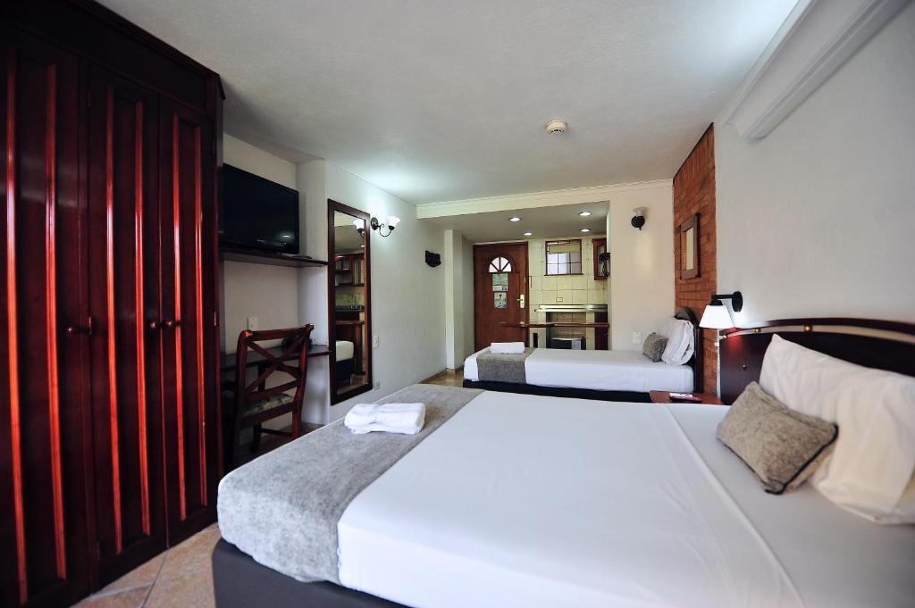 Postel nebo postele na pokoji v ubytování Hotel Cabo de la Vela Medellin