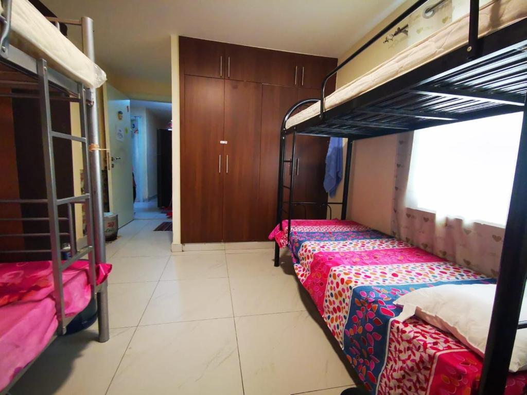 a room with two bunk beds and a hallway at Bed Space For Females Near Metro Station in Dubai