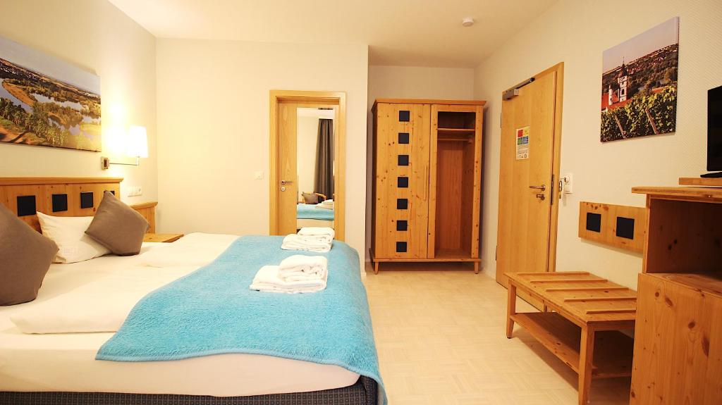Postel nebo postele na pokoji v ubytování Aparthotel Alte Schmiede Dettelbach