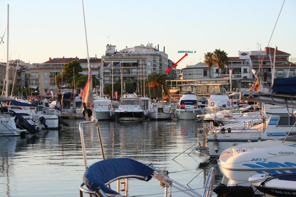 a bunch of boats docked in a marina with buildings at Abrigall II in Cambrils