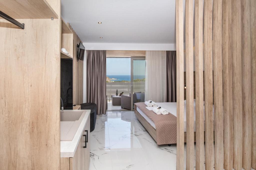 a bedroom with a bed and a sink and a tub at Xasteria in Elafonisi