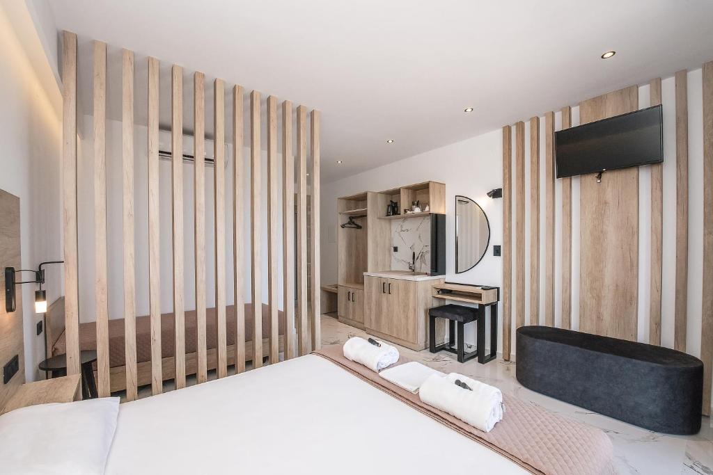 a bedroom with a large bed and a tv at Xasteria in Elafonisi
